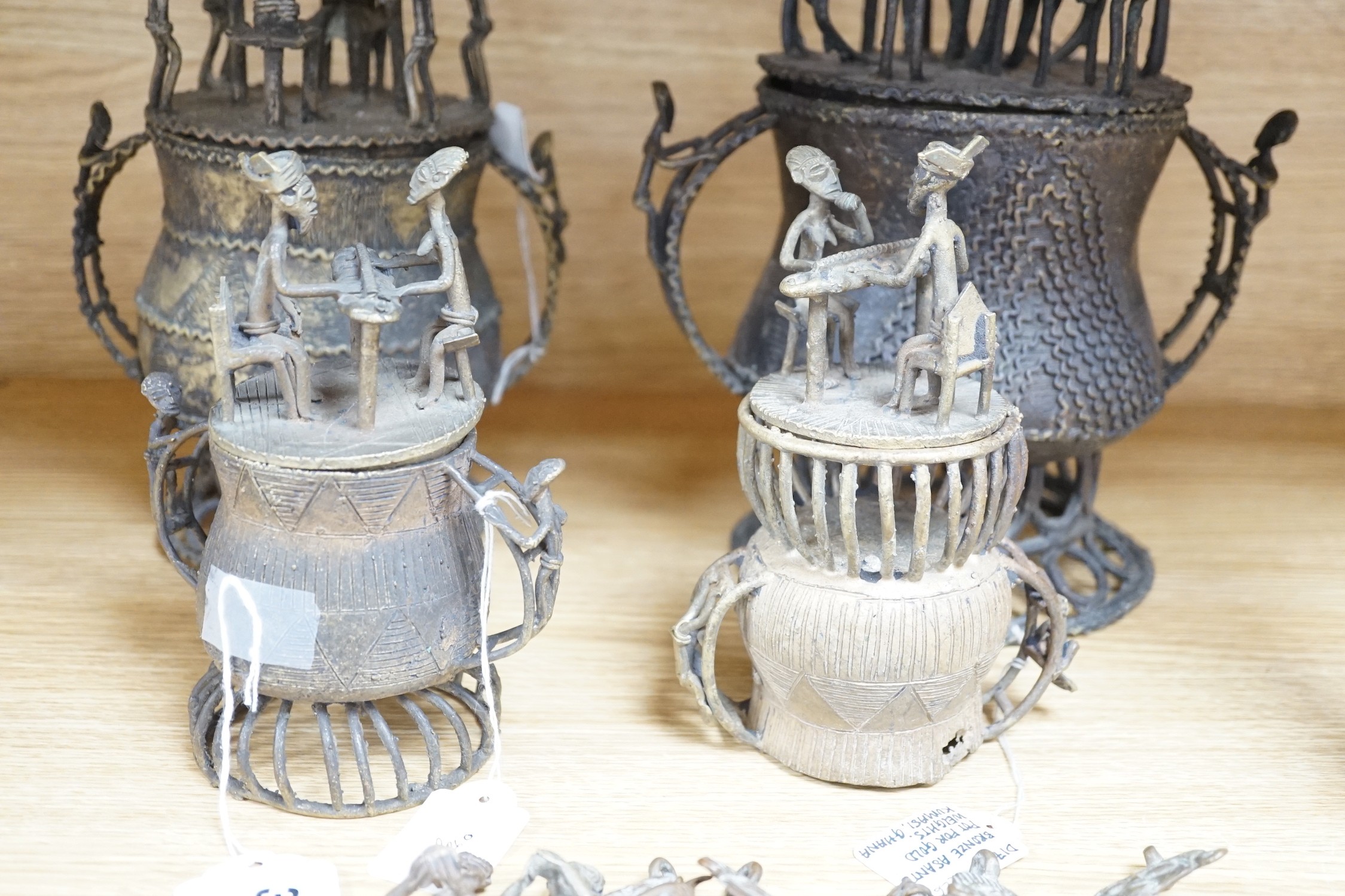A collection of four Ashanti bronze figural vessels, and nine single figures, tallest 29cms high